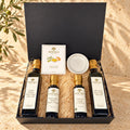 SOCALA Italian bread dipping gift set with olive oils, two balsamic vinegars, Tuscan herbs and a white dipping dish in an open black box.